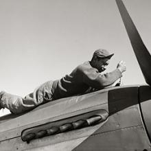 Crew chief Marcellus G. Smith of the 332nd Fighter Group works on a North American P-51D Mustang  March 1945 
