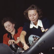 Work on a Pratt & Whitney R-1830 Twin Wasp aircraft engine mounted on a Douglas C-47 Dakota military transport