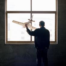 Yuan Xiangqiu gazes out the window of his home in Tiantai, Zhejiang province. The 65-year-old said he was inspired to build a plane the first time he saw one on television. "I can teach myself to be a carpenter, and I can make a rice thresher, so I can surely build an airplane too," he remembers thinking  2015