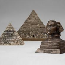 Pyramid inkwell and cigarette box  c. 1890  United States or Europe  bronze Collection of Ace Architects L2014.2902.007, .008  Sphinx  c. 1920s  New York  copper-plated lead Collection of Ace Architects L2014.2902.009