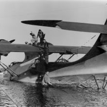Consolidated PBY-5A Catalina seaplane is filled with fuel before a flight to Hawai’i  