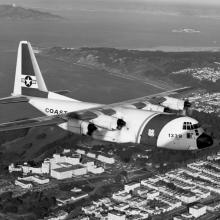 Lockheed HC-130H Hercules flies over the Golden Gate and the Veterans Administration Hospital  1976
