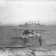 Loughead hydroplane and passenger Ralph Geddes beaching with the cruiser USS Milwaukee off the Panama-Pacific International Exposition, San Francisco  1915