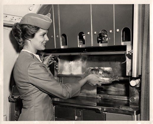 Pan American World Airways stewardess Pamela (Borgfeldt) Taylor poses in a Boeing 707 galley on her first training flight from New York to Berlin  1964