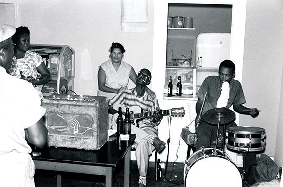 Lightnin’ Hopkins with L.C. Williams on drums at a beer joint  1961 Houston, Texas Photograph: Chris Strachwitz Courtesy of Chris Strachwitz and/or the Arhoolie Foundation R2018.1101.167