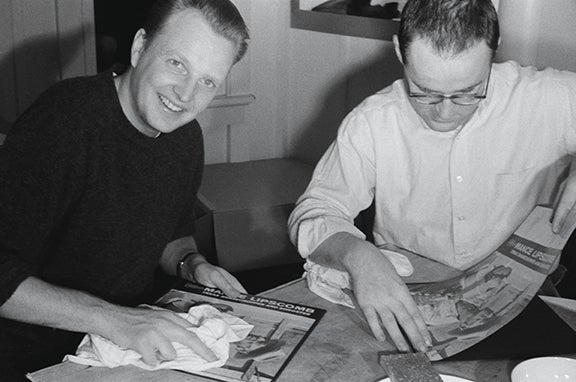 Chris Strachwitz and Wayne Pope pasting their first album covers for “Texas Songster”  1960 Photograph: Alice Pope Courtesy of Chris Strachwitz and/or the Arhoolie Foundation R2018.1101.260
