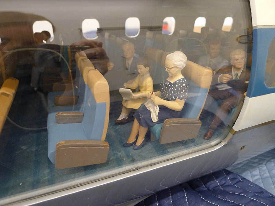 Conserving a Cutaway Model: United Air Lines Douglas DC-8 Middle section, before and after treatment (fills include one row of seats, seatback for knitting figure, arm and pad of paper for girl, and hand for male figure)